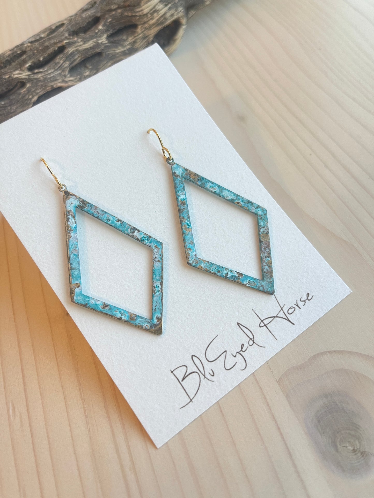 Cassidy Earrings Made in the USA with drift wood in background