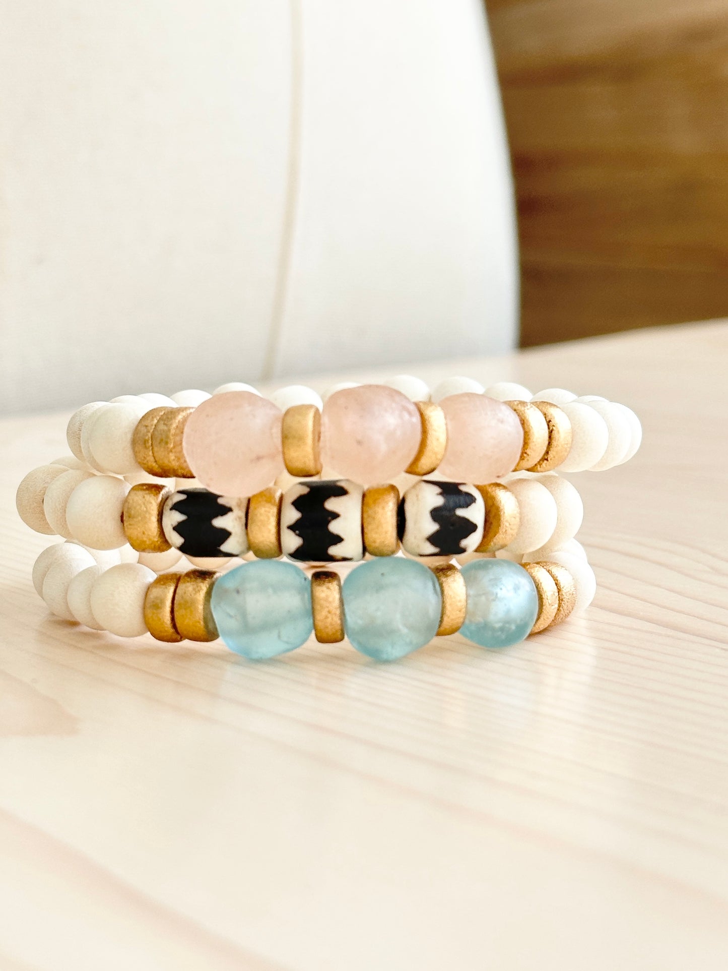 Blush, Ocean, and Zebra Batik Island Bracelets on table Handmade in the USA