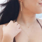 Woman wearing Hammered Bar Earrings that are Handmade in the USA while outside.