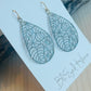 Heather Earrings Made in the USA with driftwood in background