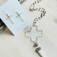 Carmen Necklace with cross earrings displayed on top of driftwood
