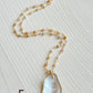 E.  Oyster shell with pink Opal gemstone beaded chain.