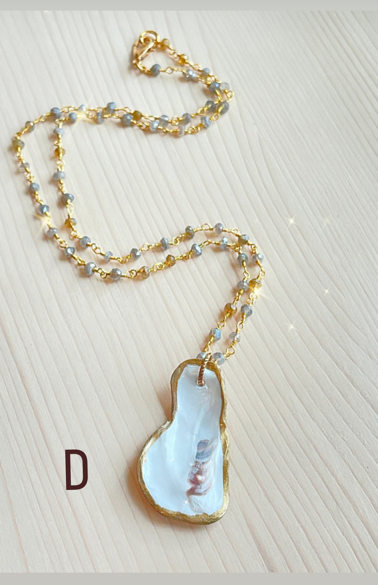 D.  Oyster shell with mystic labradorite and amber gemstone beaded chain.