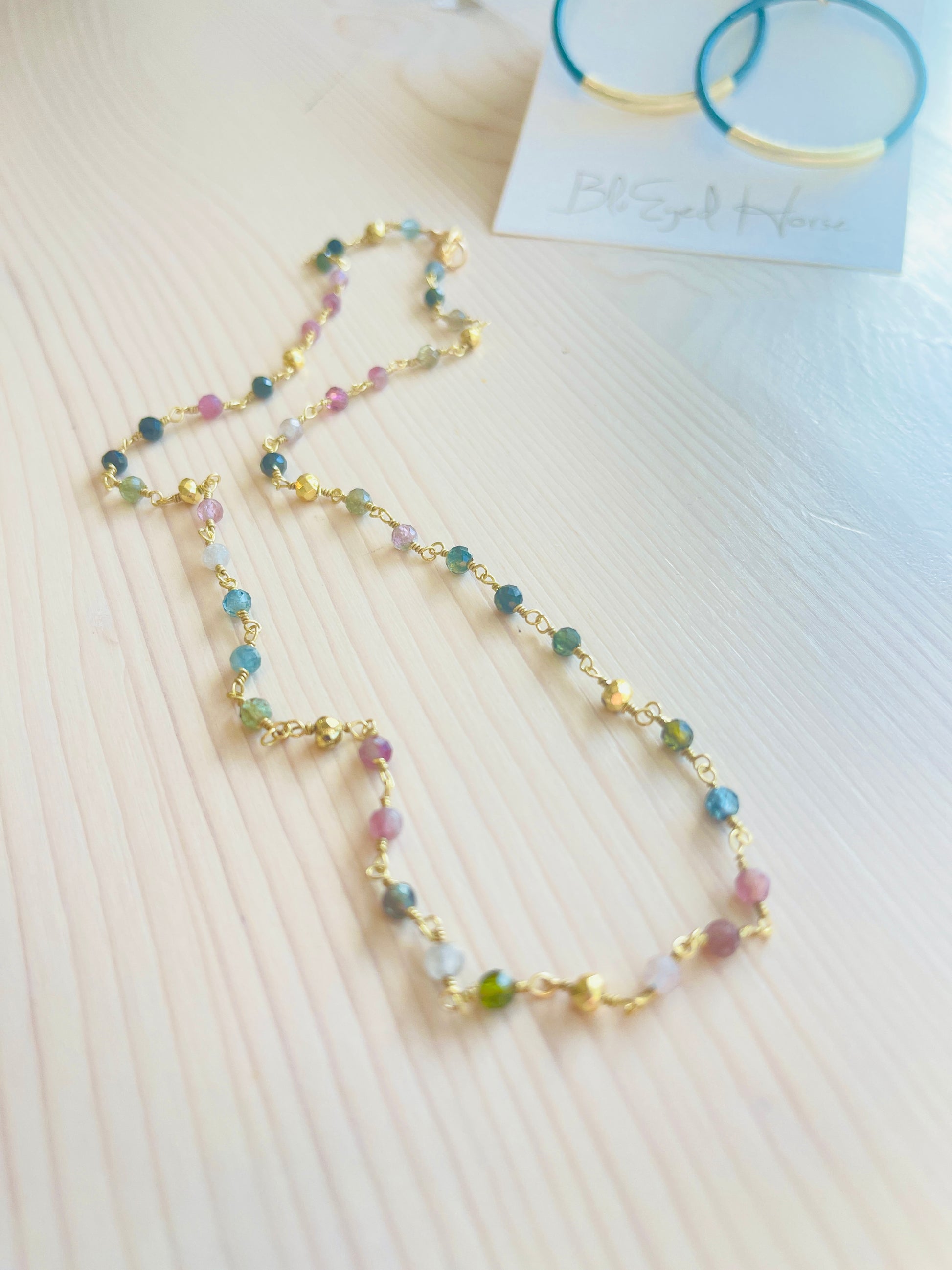 Tourmaline Choker with blue hoop earrings in the background