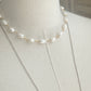 Pearl Choker displayed on driftwood with necklace on mannequin