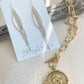 Goldie Earrings with necklace displayed on driftwood