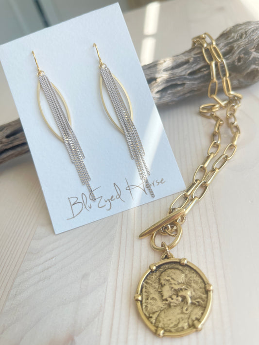Goldie Earrings with necklace displayed on driftwood
