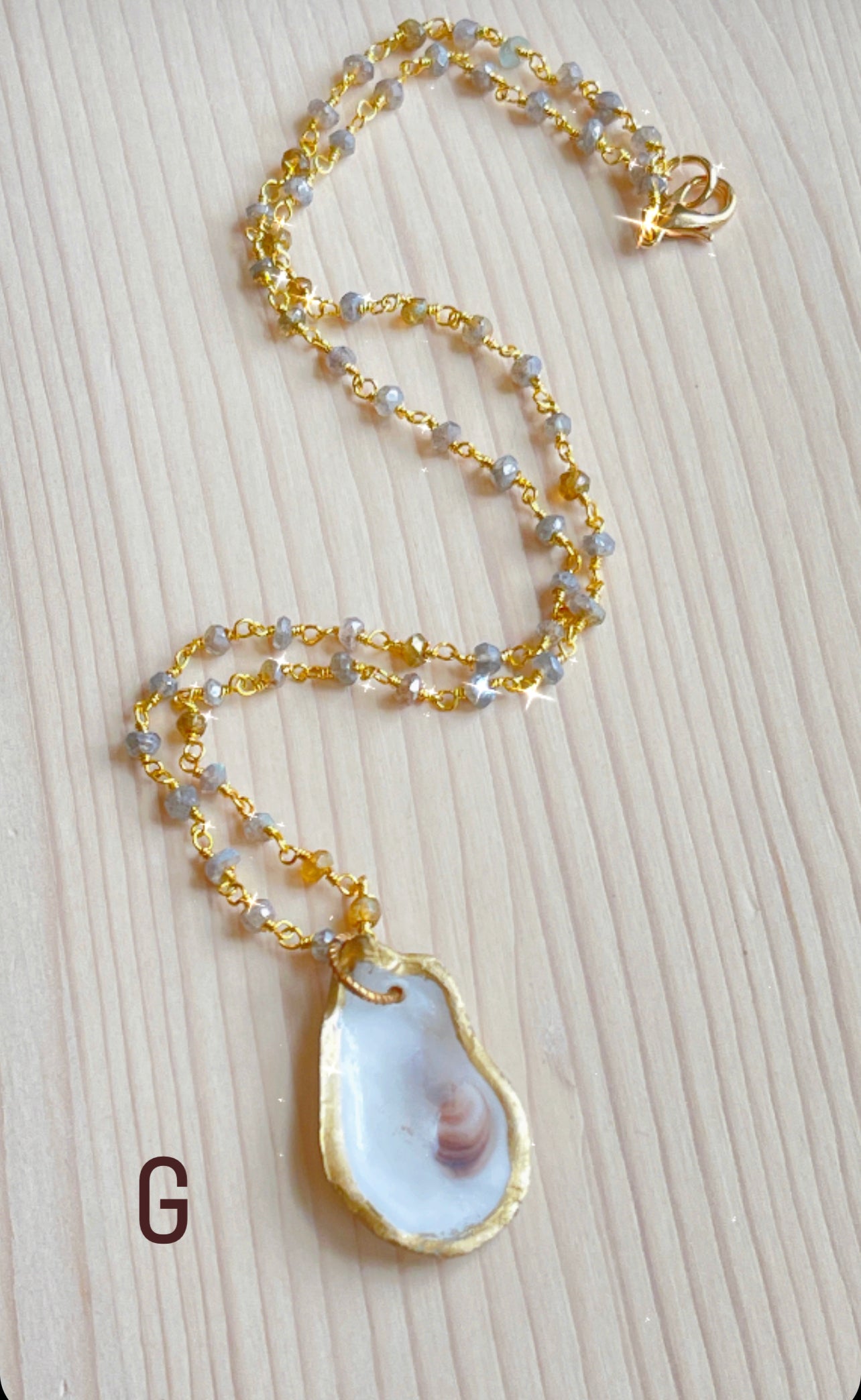 G.  Oyster shell with mystic labradorite and amber gemstone beaded chain. 