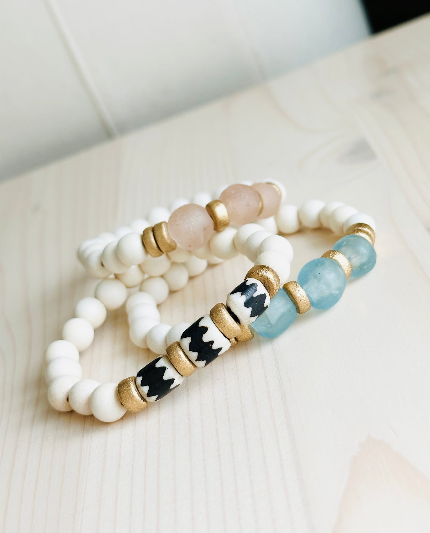 Blush, Ocean, and Zebra Batik Island Bracelets on table Handmade in the USA